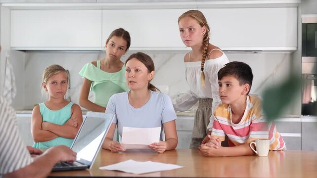 Solo mother with four children having visit of Social services worker informing about refusal of benefit 