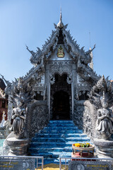 Separate fragments of a decorated Buddhist temple in Thailand on a sunny day