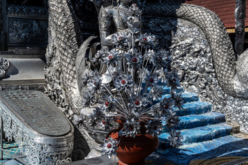 Separate fragments of a decorated Buddhist temple in Thailand on a sunny day
