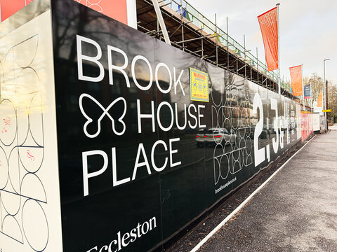Brook House Place construction site signage on a Manchester street with modern fencing visible advertising Eccleston Homes