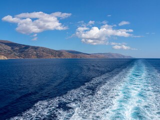 Naklejka premium Ferry track in the Aegean Sea on the background of the islands of Tinos and Andros in Greece
