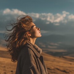 Woman breathing fresh air in mountains