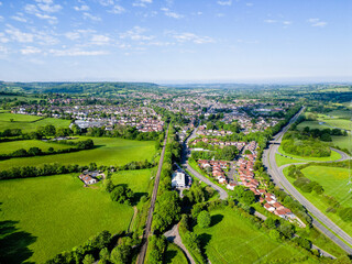 Naklejka premium Wide angle aerial drone view of Honiton in Devon, looking West along the railway line and A30 towards Exeter.