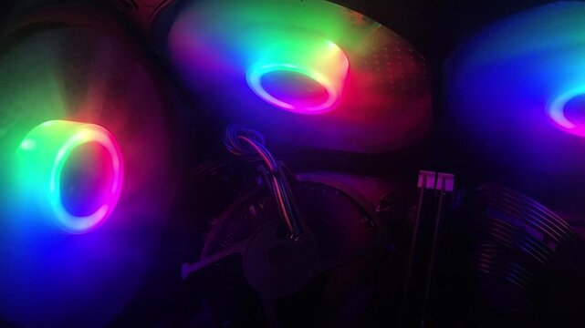 Colorful RGB CPU Cooling Fan Spinning Inside Gaming Computer Case. 4K Video