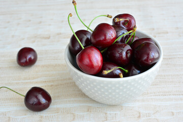 Fresh Red Cherries in a White Bowl copy space