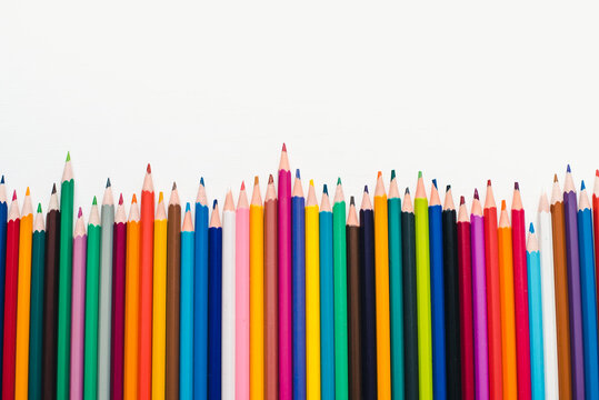 Colored pencils on a white background. Background of multicolored pencils.