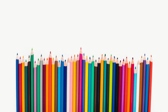 Colored pencils on a white background. Background of multicolored pencils.