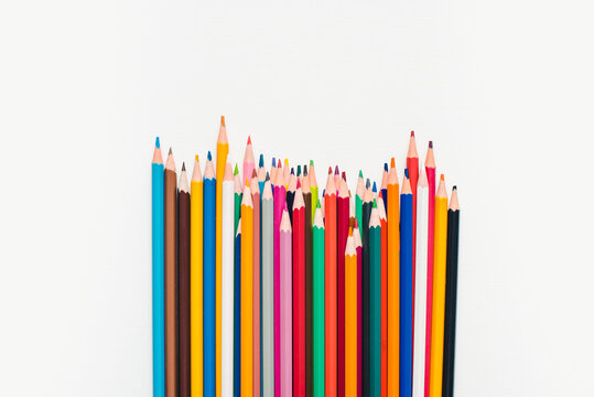 Colored pencils on a white background. Background of multicolored pencils.
