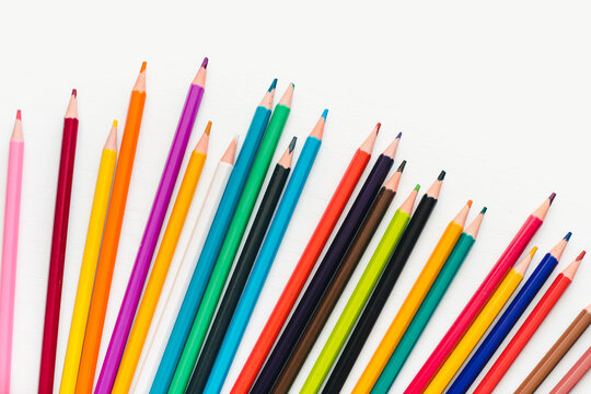 Colored pencils on a white background. Background of multicolored pencils.