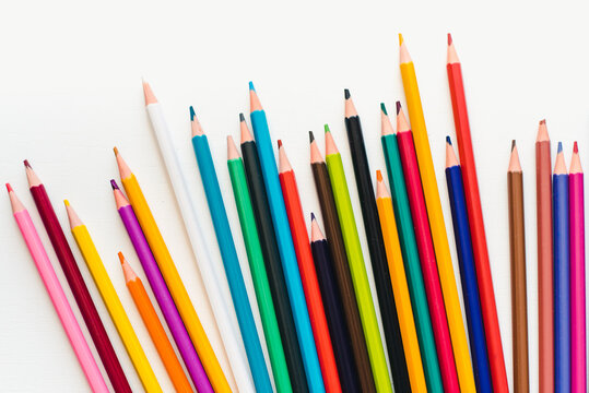 Colored pencils on a white background. Background of multicolored pencils.