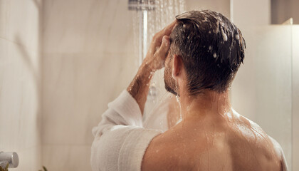 Bathing man in shower robe, washing hair in bathroom. Suitable for personal hygiene, selfcare, daily routine, shower product concepts.