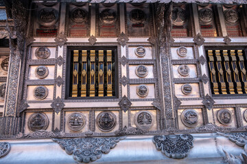 Separate fragments of a decorated Buddhist temple in Thailand on a sunny day