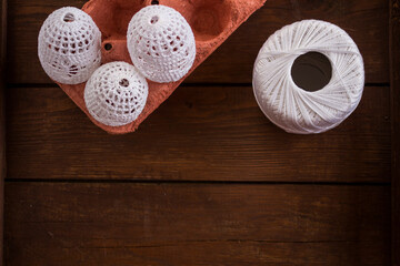 vertical Easter background, crochet Easter eggs, handmade decoration, white lace eggs, rustic wooden table, egg carton, spring holiday, farmhouse decor, country style, slow living, cozy atmosphere, ho