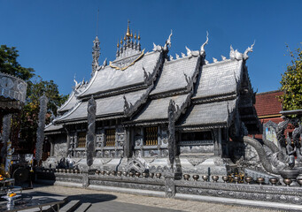 Separate fragments of a decorated Buddhist temple in Thailand on a sunny day