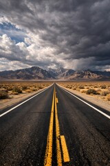 Obraz premium Long Straight Highway Through Desert Valley Toward Mountain Range Under Dramatic Storm Sky, Scenic Travel Journey Landscape, Wide Angle Road Perspective