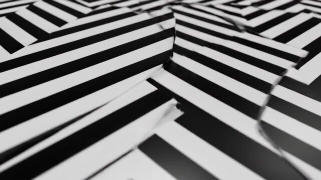 A close-up, angled view of a repeating black and white chevron pattern on folded paper