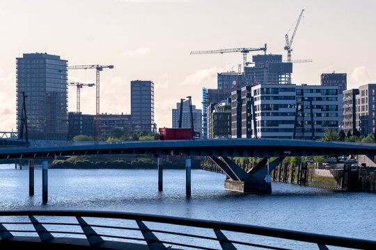Daylight river bridge links modern urban skyline and architecture along Hamburg Germany waterfront creating clean cityscape for travel marketing