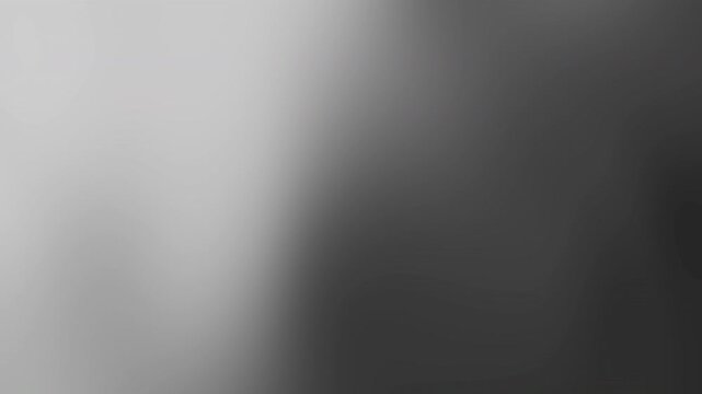 A blurred abstract image showcasing gradient, shadow, and texture in a monochrome, close-up perspective from a unique viewpoint