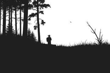 Fototapeta premium Silhouette of a man standing on a hill surrounded by trees