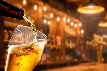 Beer Pour from Bottle to Cold Glasswith Blurred Pub and Bar Lights Scene at Night