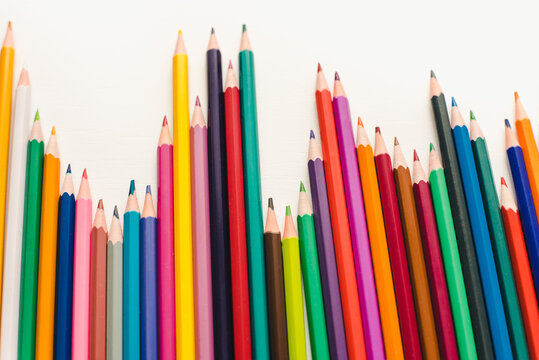 Colored pencils on a white background. Background of multicolored pencils.