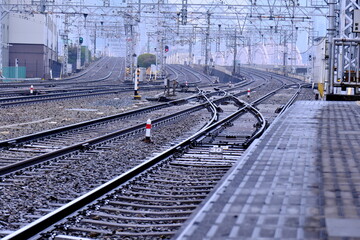 Fototapeta premium Complex railway junction and multiple tracks at a station. High-density rail infrastructure in Japan