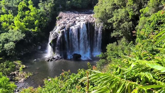Cascade at Bassin Nicole and Bassin Boeuf, Sainte Suzanne, la Reunion. Strong waterfall in lush tropical environment, during rainy season