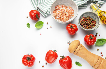 Fresh cooking ingredients with tomatoes, basil, pepper, and salt