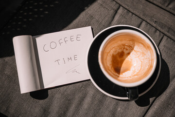 Coffee break with a handwritten note and an empty cup on a cozy surface