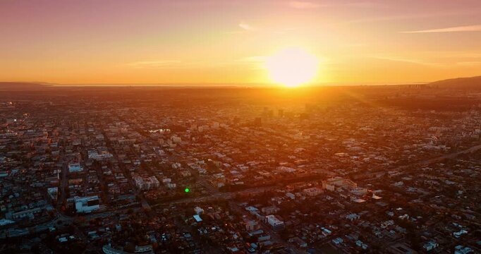 Los Angeles, USA, 11 January 2026: Low-rise vast urban landscape covered with soft setting sun. Drone flight over uptown Los Angeles, California, USA at sundown.