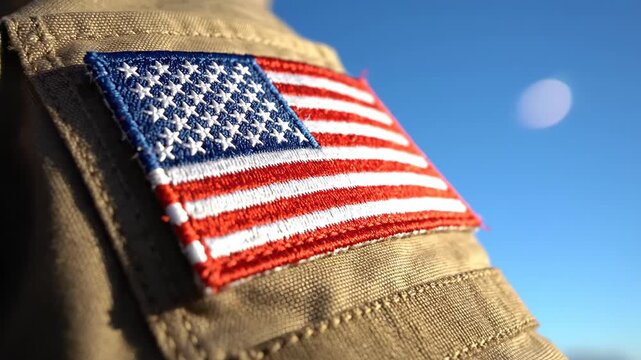 American flag patch on military uniform sleeve against blue sky