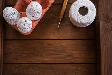 vertical Easter background, crochet Easter eggs, handmade decoration, white lace eggs, rustic wooden table, egg carton, spring holiday, farmhouse decor, country style, slow living, cozy atmosphere, ho