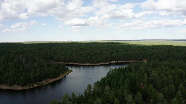 Wide establishing drone shot of the Woods Canyon Lake blanketed by clouds in Arizona's summer.