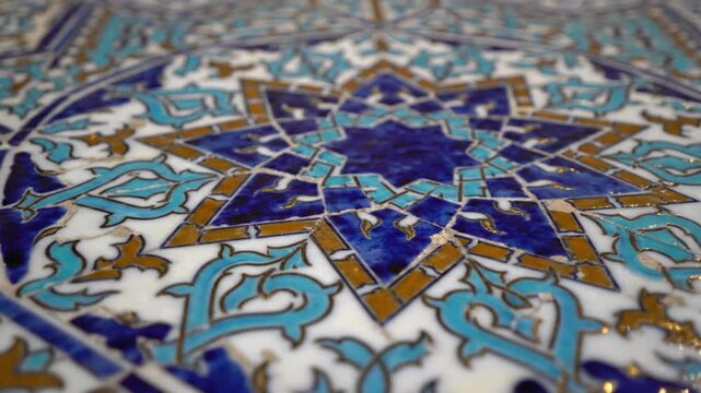 Ornate tiled surface featuring a central geometric star motif surrounded by intricate blue white and gold scrolling patterns