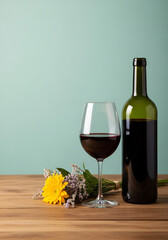 Vivid Red wine and flower still life on wood