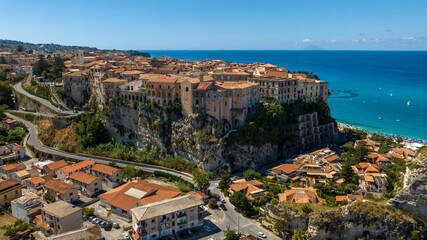 Aerial view of the historic center of Tropea, in the province of Vibo Valentia, Calabria, Italy. It is a town perched on a hill, with the Mediterranean Sea and the island of Stromboli on the horizon. © Stefano Tammaro