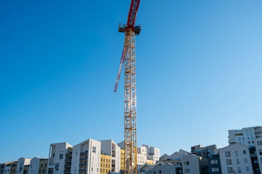 Industry crane and construction skyline above urban development architecture in Port Marianne Montpellier France showing city expansion and progress