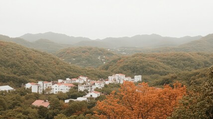 Obraz premium Autumn Landscape of a Scenic Village Surrounded by Colorful Hills and Mountains in Nature