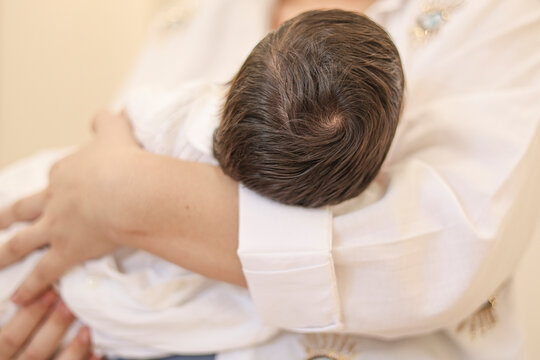 Newborn baby being held in arms during the first days of life. 