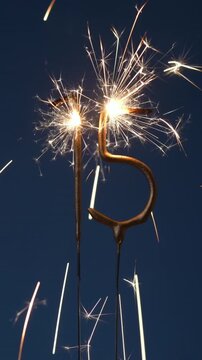 15 years celebration festive vertical footage made with Bengal fires in the form of number Fifteen.