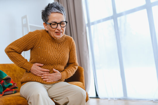 Senior woman suffering from severe abdominal pain