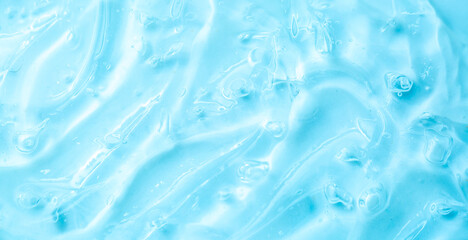 Cosmetic gel, serum, clear sample with a blue tint, close-up. Liquid cream with a foaming texture....