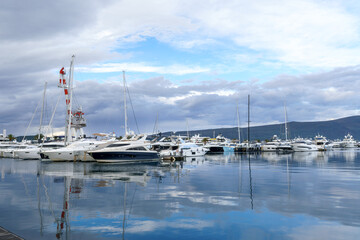Luxury yachts in the seaport of Tivat, Montenegro. Bay of Kotor, Adriatic Sea. Great tourist destination. Beautiful summer landscape.