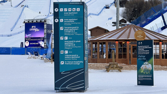Livigno, Italy - February 9, 2026: Milano Cortina 2026 Olympic wayfinding sign with training areas, hospitality and podium directions at big air venue