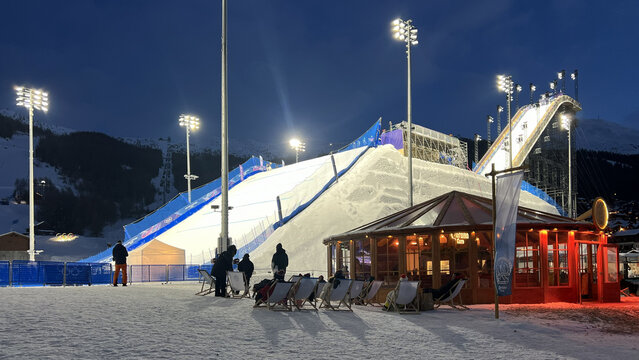 Livigno, Italy - February 9, 2026: Snowboard Big Air venue illuminated at night during Milano Cortina 2026 Winter Olympic Games in the Italian Alps