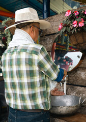 A farm man washing his hands