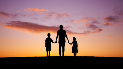 Fototapeta premium A beautiful silhouette captures a mother holding hands with her son and daughter against a breathtaking sunset sky.