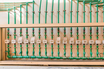 Water meters and green pipes creating a plumbing network for utility infrastructure