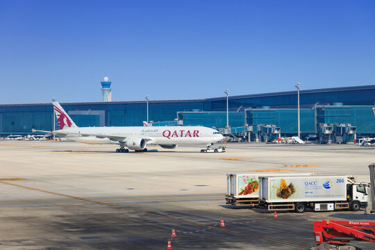 2 December 2025, Doha, Qatar: Qatar Airways Boeing 777 aircraft parked at Hamad International Airport terminal
