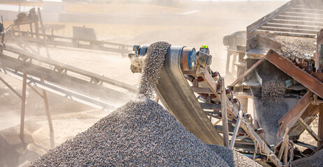 Vibrating screen stone crusher in operation. Crushing stones in a quarry for processing minerals,...